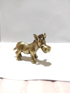Miniature brass donkey figurine with a smiling cartoon face and antique gold finish