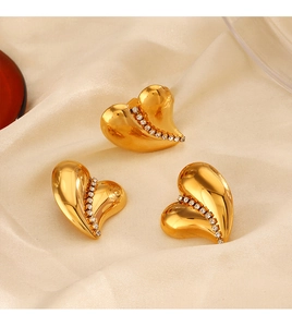 Detailed view of three 18K gold-plated heart jewelry pieces with sparkling rhinestones