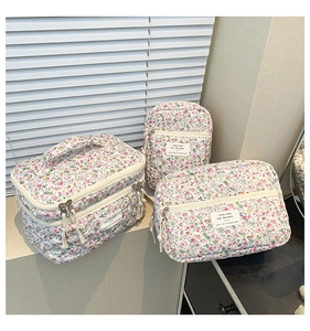 Three-piece floral quilted cotton makeup bag set including a large vanity case and pouches