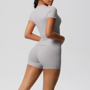 Close-up of seamless light grey high-stretch yoga set with t-shirt and high-waisted shorts