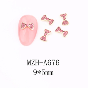 Detail of pink rhinestone bow nail art charms with gold metal base and 9x5mm size display