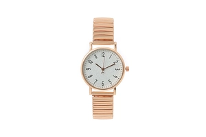 Close-up of rose gold elastic band watch with white textured dial and Arabic numerals