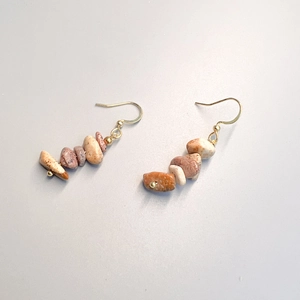 Detail of handmade boho fishhook earrings with colorful natural crushed stone beads