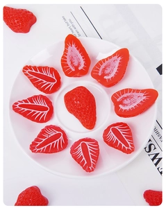 Detailed realistic strawberry miniatures showing sliced interior textures and seeds
