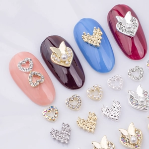 Mixed alloy heart and butterfly nail charms with pearls and rhinestones on colorful tips