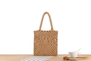Macro detail of beige cotton rope macrame knotting on a bohemian woven handbag
