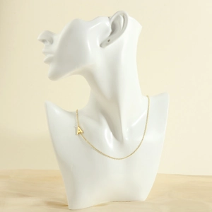 Detail of 18K gold-plated necklace with letter A pendant on a white mannequin