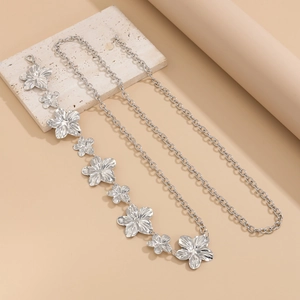 Detailed view of silver flower waist chain with starfish petals and lobster clasp