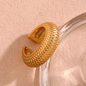 Detailed close-up of 18K gold plated ring featuring intricate fish scale texture on band