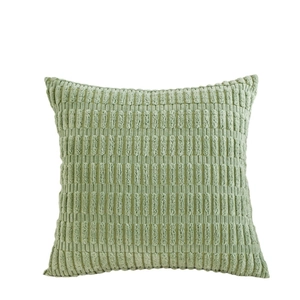 Green velvet throw pillow with striped tufted texture on a plain white background