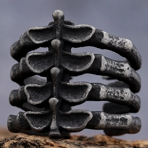 Gothic style skeletal bone open ring in vintage silver finish on natural stone base