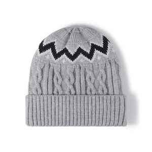 Chunky cable knit winter beanie with black and white zigzag pattern and ribbed cuff