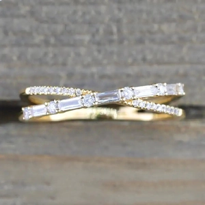 Minimalist gold criss-cross ring with micro-paved round and baguette gemstones