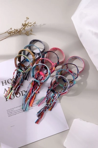 Detail of colorful bohemian braided cotton friendship bracelets with long tassels