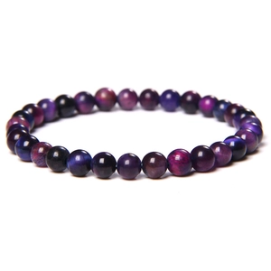 Macro view of purple and blue tiger eye stone beads bracelet with cat eye effect texture