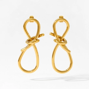 Minimalist gold knot drop earrings with a polished finish on a clean white background