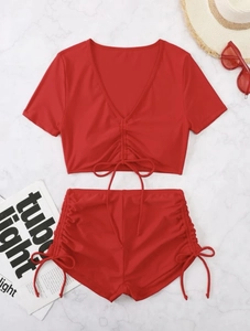 Close-up of vibrant red two-piece bikini with adjustable drawstring ruching detail