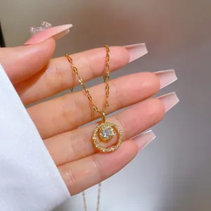 Detailed macro of gold-plated circular pendant featuring micro-pave zircons and center stone