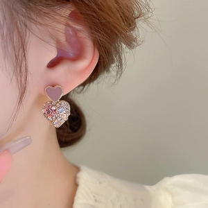 Detail of pink and purple heart earrings with sparkling crystals and gold plating