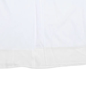 Macro shot of the side split hem on a white dress showing fine stitching and fabric texture