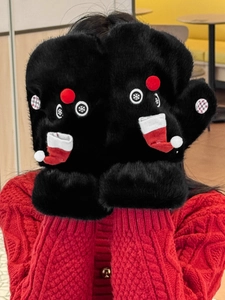 Detail of plush black mittens with cute reindeer eyes and festive 3D Christmas sock accent