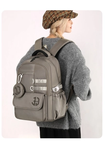 Minimalist grey-taupe large capacity backpack with side pocket and small round pouch