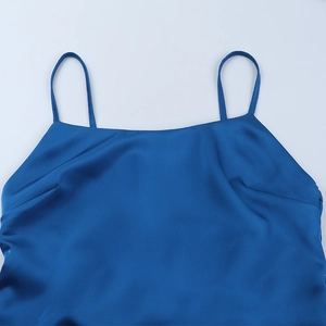 Detail of royal blue satin camisole showing sleek neckline and thin spaghetti straps