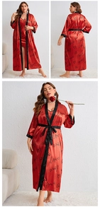 Detail of red satin lace-up robe set featuring black love heart patterns and silky texture