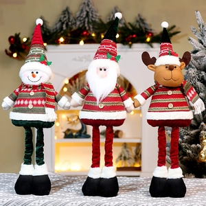 Three plush Christmas figurines of Santa, Snowman, and Reindeer in festive knitted outfits