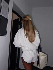 Back view of white cotton sports set with half-zip hoodie and loose shorts