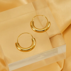Polished 18K gold-plated chunky C-shaped hoop earrings on elegant silk background