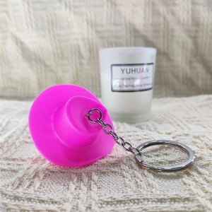 Pink mini hat disco keychain with silver chain on a cozy beige knitted background