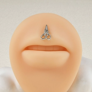 Macro view of silver scissor shaped stainless steel push-in labret on lip model