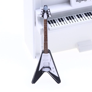 Detailed close-up of a miniature V-shaped electric guitar model for dollhouse scenes