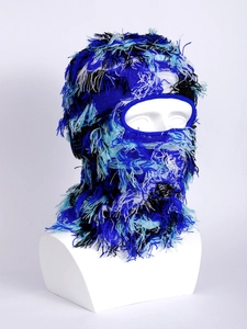 Detail of distressed knitted balaclava with long fringe and blue white yarn texture