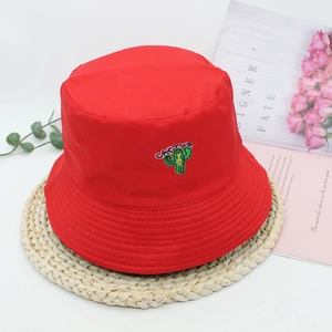 Red canvas bucket hat with green cactus embroidery and Cactus text on beige mat