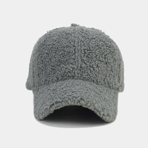 Detailed texture of gray sherpa fleece fabric on a warm winter baseball cap