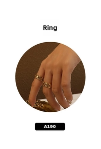 Detail showing two gold chain rings with vintage metallic texture worn on fingers
