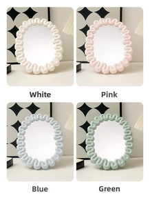 Detail view of wavy border desktop makeup mirrors in white, pink, blue, and green options