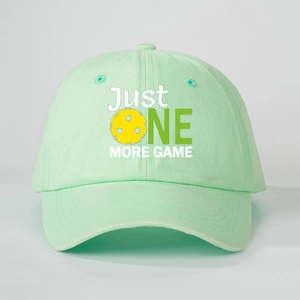 Close-up of mint green cotton baseball cap with JUST ONE MORE GAME pickleball print