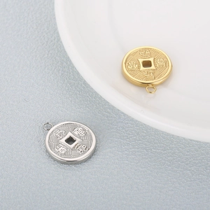 Traditional Chinese coin pendants in gold and silver finish on textured background