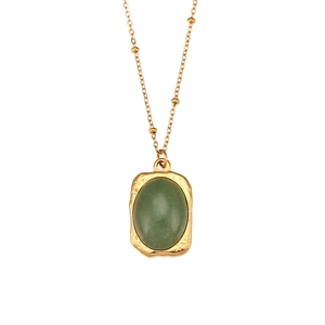 Vintage gold wavy chain necklace featuring an oval green natural stone pendant