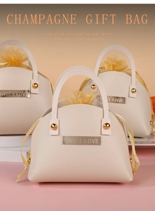 Detail of champagne leather wedding gift bags with Sweet Love gold hardware and tulle