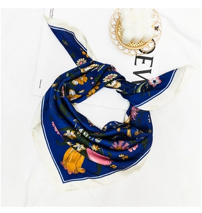 Detailed view of dark blue silk scarf featuring realistic floral prints and bees