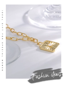 Detailed close-up of golden sunflower pendant necklace with white opal stone