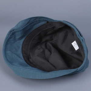 Detail view of cotton sun hat interior featuring black sweatband and 100% cotton label
