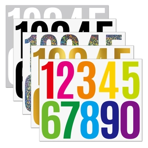 Macro view of assorted 3-inch waterproof vinyl number stickers in metallic and laser finishes