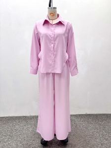 Detail view of pink notched lapel shirt and high-waist wide-leg trousers fashion set