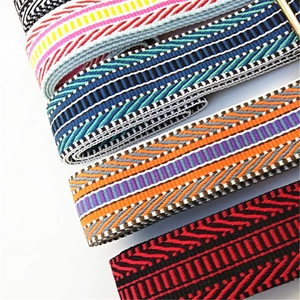 Close-up of wide bohemian style woven bag straps with diverse ethnic stripe patterns