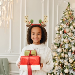 Close-up of reindeer antler headband with gold sequins and festive holiday decorations
